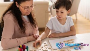 In an ABA therapy session, a female therapist guides a young boy in a matching puzzle game during a focused moment.