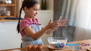 In an ABA therapy session, a young girl bakes in the kitchen, looking happy, proud, and capable.