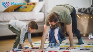 A father or therapist plays Twister on the floor with a boy and girl, engaging them in a playful autism intervention activity.